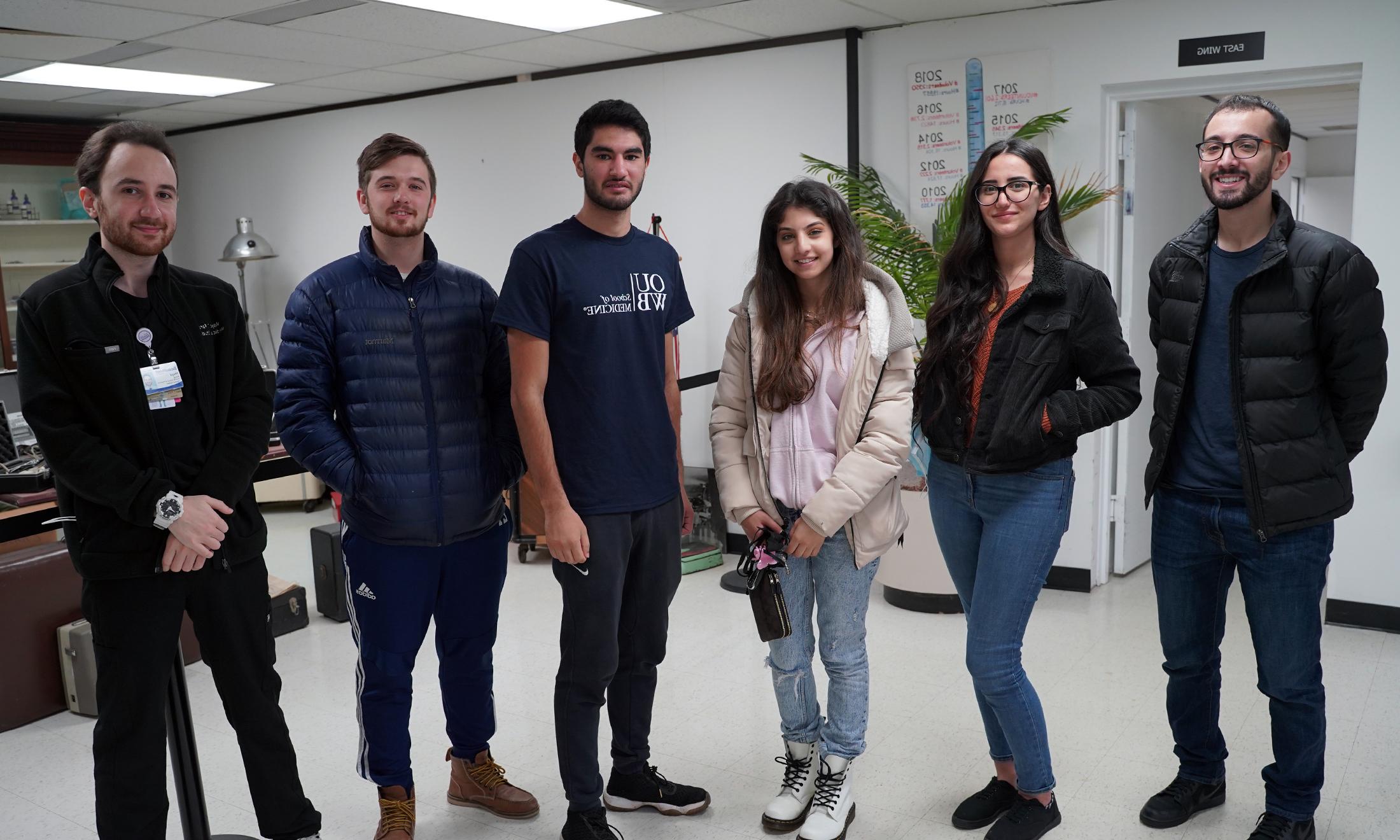 A group of students leading a food drive for Lebanon poses for a picture