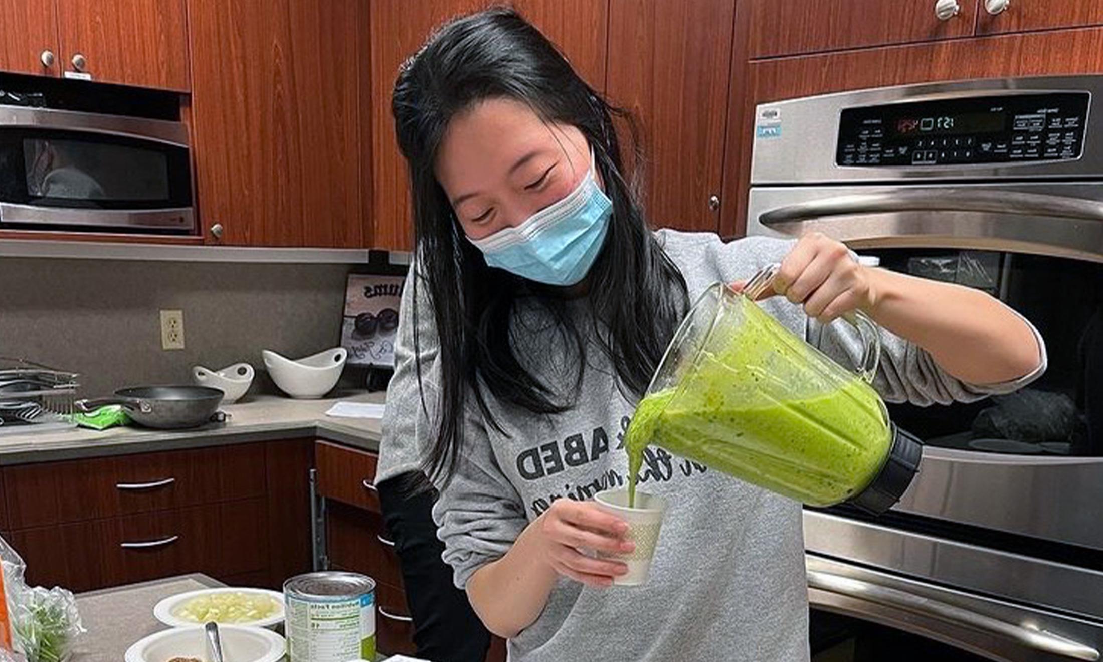 An image of a student pouring a smoothie