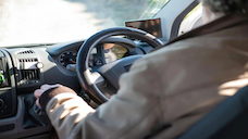 A stock image of a person driving a car.